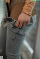 A close up of a person wearing a pair of jeans.