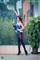 A woman dressed as a bunny holding a gun.