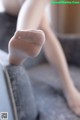 A close up of a woman's legs in white stockings.