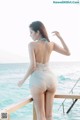 A woman standing on a pier near the ocean.