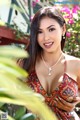 A woman in a colorful dress posing for a picture.